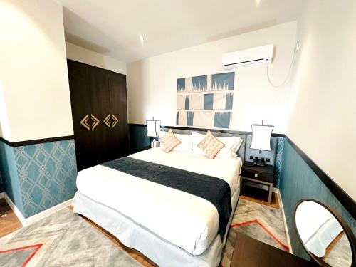 a hotel room with a bed and a mirror at Somerset City Centre Atyrau in Atyraū