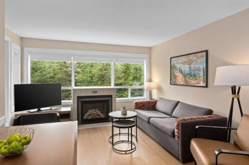 a living room with a couch and a fireplace at Worldmark Whistler Sundance in Whistler