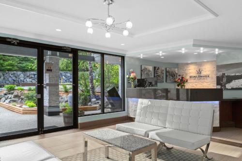 a living room with a white couch and windows at Worldmark Whistler Sundance in Whistler