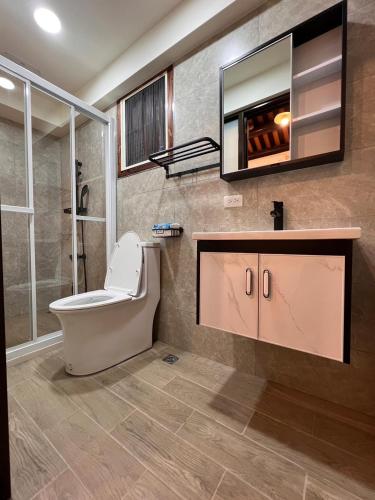a bathroom with a toilet and a sink at 心如所院民宿 in Hsia-shih