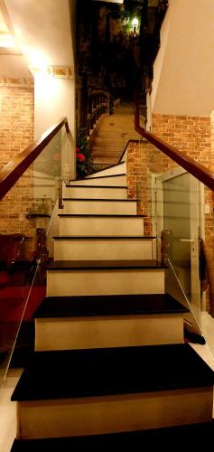 a set of stairs in a building with a stair case at Long Homestay Xuyên Á - Hotels in Ðức Hòa