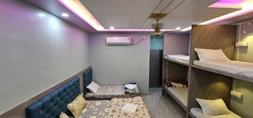 a room with two bunk beds and a couch at Kashi Om Vilas Homestay in Varanasi