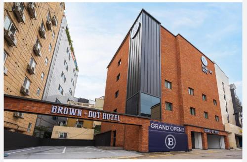 a brick building with a sign in front of it at Brown Dot Hotel Suwon Jeongja Branch in Suwon