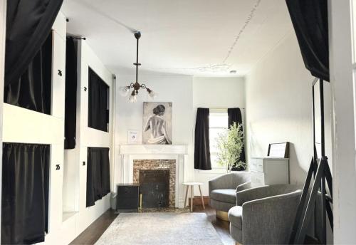 a living room with a chair and a fireplace at Burlington Hostel in Los Angeles