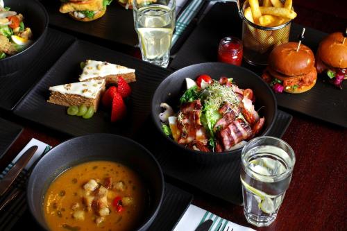 a table topped with bowls of food and sandwiches at Sheraton Poznan Hotel in Poznań