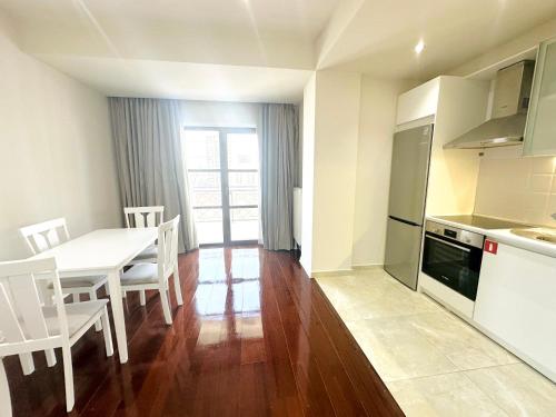 a kitchen and dining room with a table and chairs at Somerset City Centre Atyrau in Atyraū