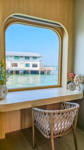 a window with a view of a pier at Moonlight Kohlarn in Ko Larn