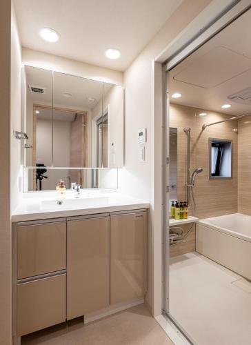 a bathroom with a sink and a tub and a mirror at Akasaka Residence in Tokyo