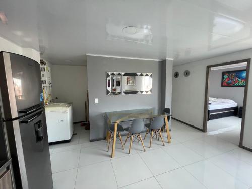 a kitchen and dining room with a table and chairs at Hotel Las Vegas in Guatapé