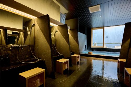 a large bathroom with a shower and a sink at Matsuya Bekkan in Kumamoto