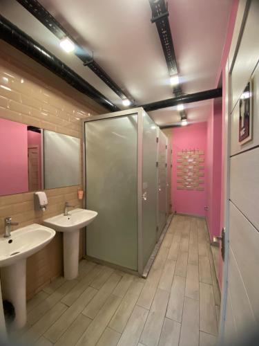 a bathroom with two sinks and a shower at Central Hostel in Sheki