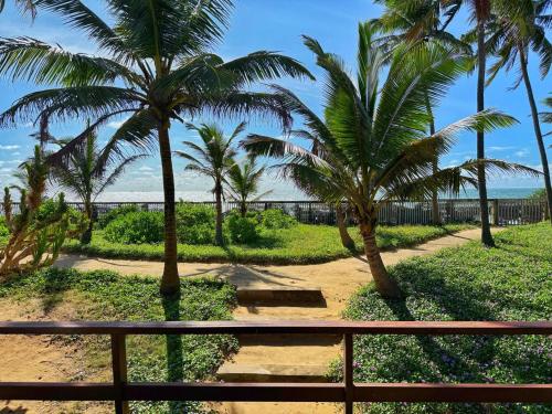 a view from the balcony of a resort with palm trees at Villa Margot by Ceylon Spaces in Pamunugama