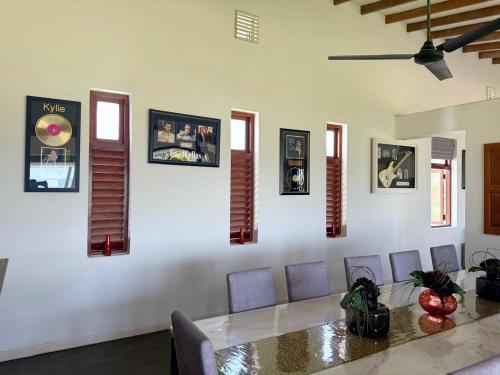 a dining room with a table and some pictures on the wall at Villa Margot by Ceylon Spaces in Pamunugama