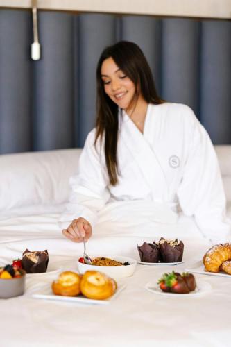 a woman sitting at a table with plates of food at Sheraton Grand Los Angeles in Los Angeles