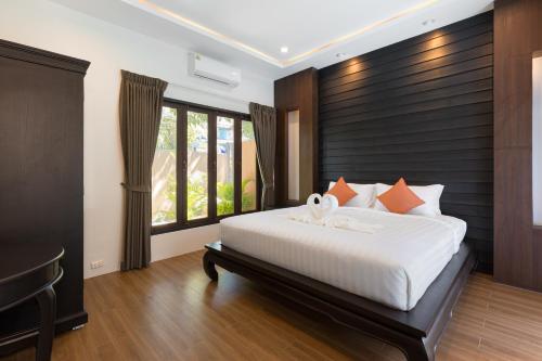 Ένα ή περισσότερα κρεβάτια σε δωμάτιο στο Blue Palm Residence Kata