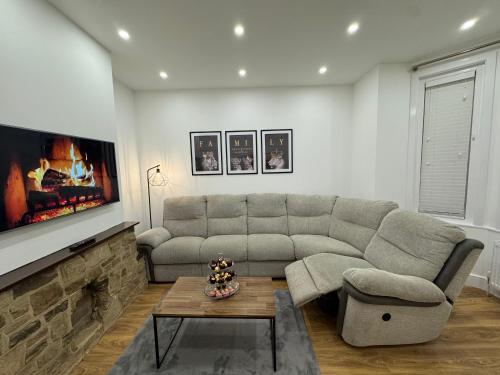 a living room with a couch and a table at Serenity House in Bournemouth