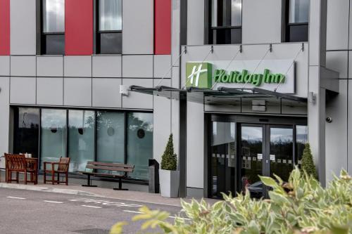 a building with a hudson turn sign on it at Holiday Inn London Luton Airport by IHG in Luton