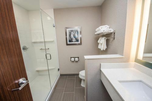a bathroom with a toilet and a glass shower at Fairfield Inn & Suites by Marriott Huntsville in Huntsville