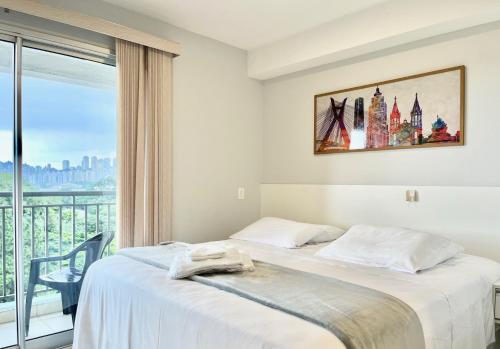 a hotel room with a bed and a window at Flat WiseSP - Expo Anhembi in Sao Paulo