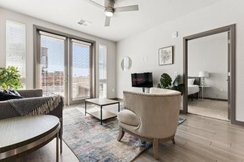 a living room with a couch and chairs and a tv at Cozysuites PHX RORO Gym Pool Pets Parking #17 in Phoenix
