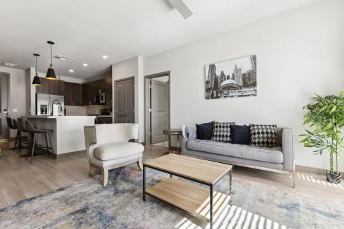 a living room with a couch and a table at Cozysuites PHX RORO Gym Pool Pets Parking #17 in Phoenix