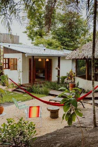 a house with a red hose in front of it at Recanto Alter do Chão in Alter do Chao