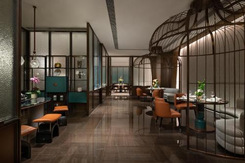 a restaurant with tables and chairs in a room at Fashion Town Hotel Shenzhen MGallery Collection in Shenzhen