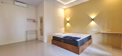 a bedroom with a bed in the corner of a room at Tangkoko Hideaway Cottage in Pulau Mogogimbun