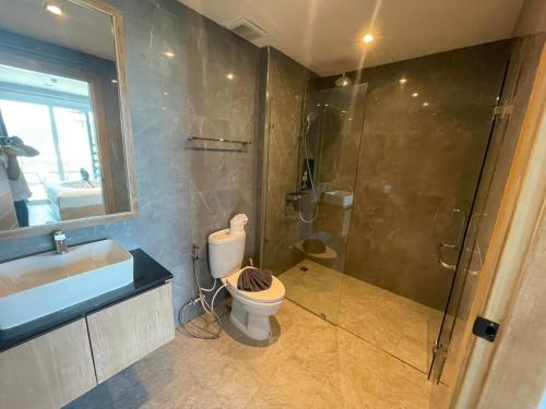 a bathroom with a shower and a toilet and a sink at Emerald Terrace Resort 2 bedrooms Panoramic Ocean View Top Floor in Patong Beach
