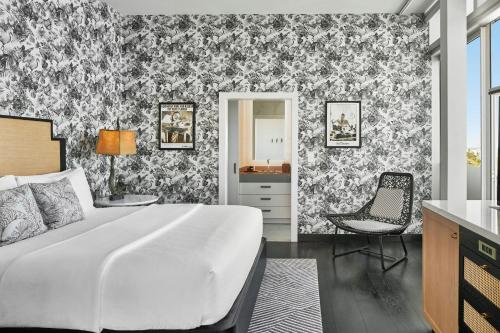 a bedroom with a bed and a desk and a chair at La Concha Key West, Autograph Collection in Key West