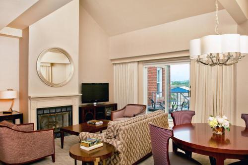 a living room with a couch and a table at Sheraton Portsmouth Harborside Hotel in Portsmouth