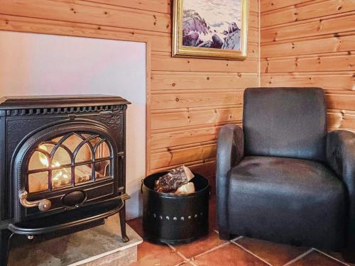a living room with a chair and a stove at 6 person holiday home in Leikanger in Leikanger