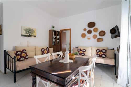 a living room with a table and a couch at Coastal Key 3 in Gázion