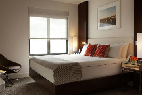 a bedroom with a large bed with a window at The Alexander in Indianapolis