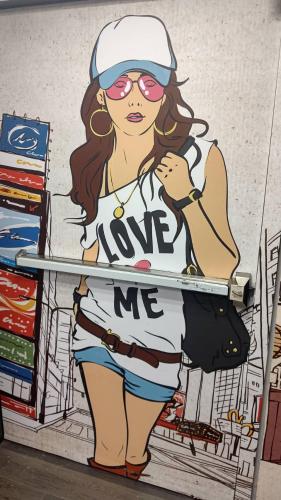 a drawing of a woman with a sign that says love me at Sleep Taipei Hotel - Nanya in Taipei