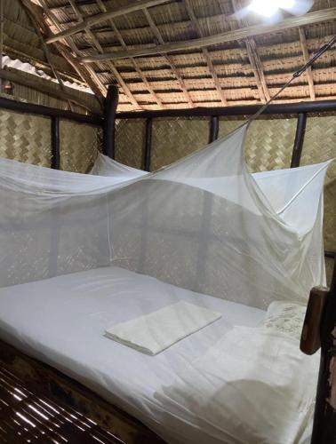 a bed is covered in plastic in a tent at Ocam Ocam Sunset View Cottages in Busuanga
