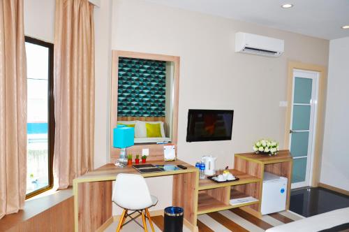 a room with a desk and a computer in it at Valya Hotel, Ipoh in Ipoh