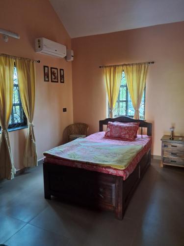 a bedroom with a large bed and two windows at Villa Effy 3 Bedrooms - Entire Villa 1800 sq ft in Carmona