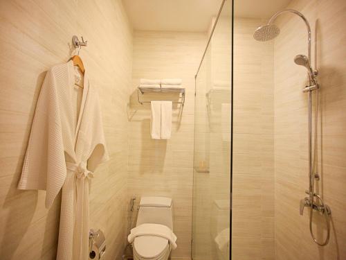 a bathroom with a toilet and a glass shower at Chabana Kamala Hotel in Kamala Beach