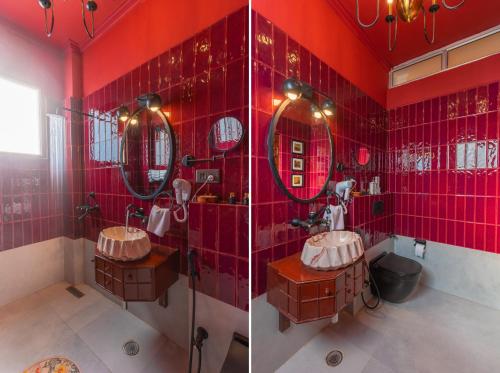 a red bathroom with two sinks and mirrors at Seclude Tea Estate, Palampur in Pālampur