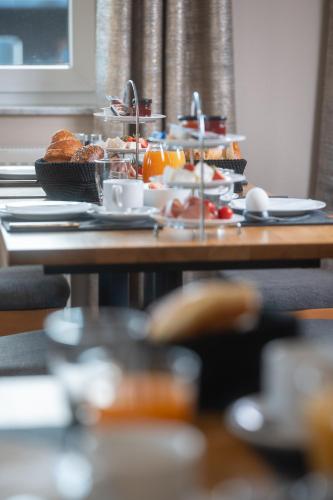 a table with a bunch of food on it at Roots Hotel Restaurant in Gomaringen