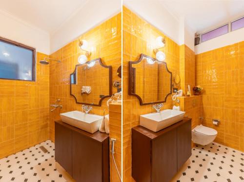 a bathroom with two sinks and two mirrors at Seclude Tea Estate, Palampur in Pālampur