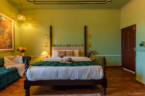 a bedroom with a large bed and a couch at Seclude Tea Estate, Palampur in Pālampur