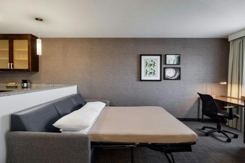 a small room with a table and a kitchen at Residence Inn by Marriott Chicago Wilmette/Skokie in Wilmette