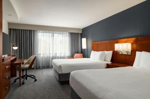 a hotel room with two beds and a desk at Courtyard Mt. Holly Westampton in Westampton Township