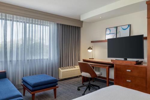 a hotel room with a desk and a television at Courtyard Mt. Holly Westampton in Westampton Township