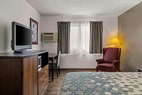 a hotel room with a bed and a flat screen tv at FairBridge Inn Express Billings Airport in Billings