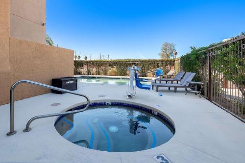a swimming pool with a water fountain on a patio at Comfort Inn & Suites near Kino Sports Complex in Tucson