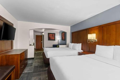 a hotel room with two beds and a flat screen tv at Comfort Suites Denver Tech Center in Centennial