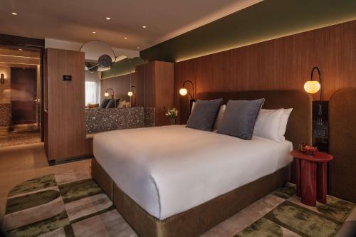 a bedroom with a large bed and a kitchen at The EVE Hotel Sydney in Sydney